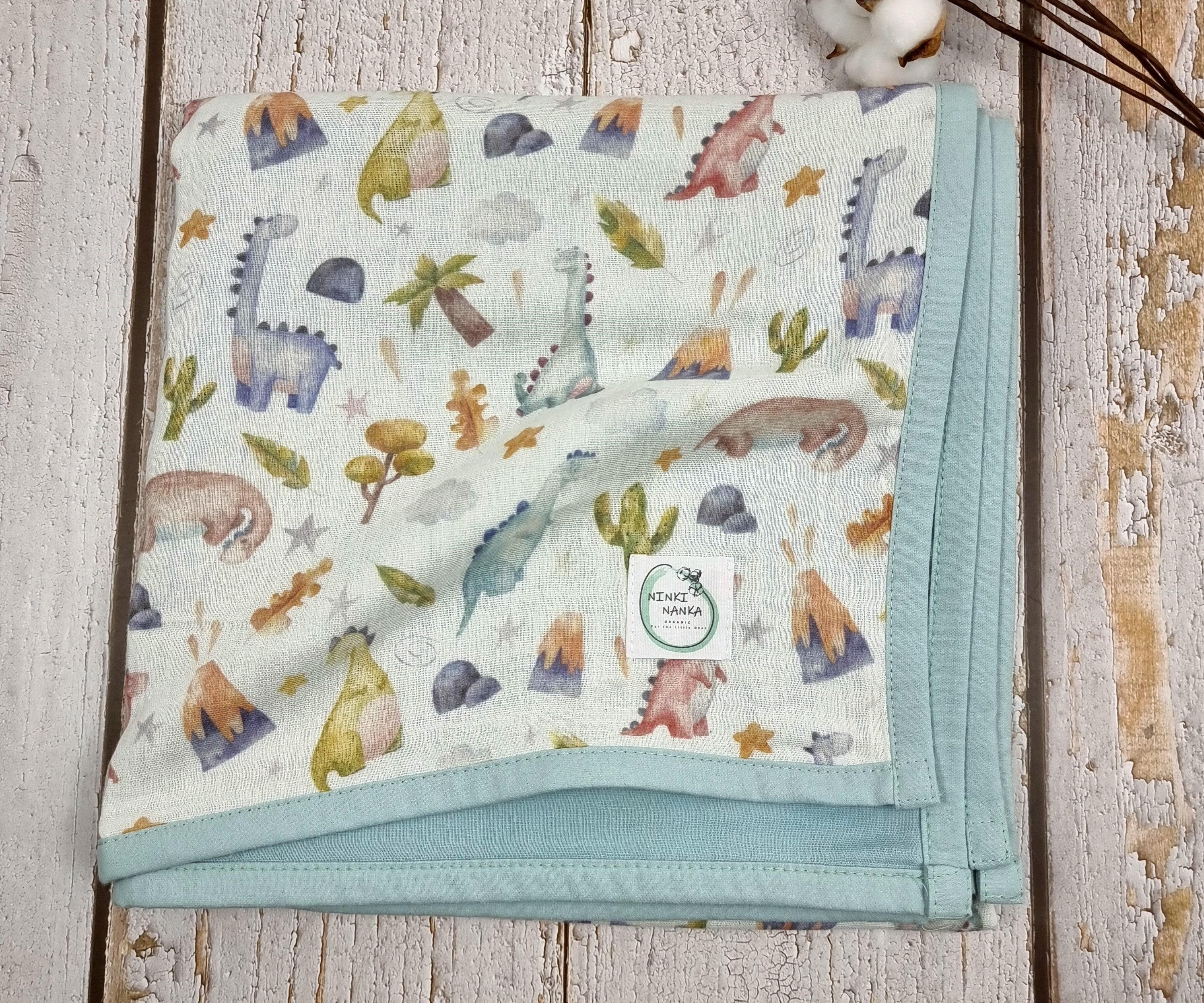 Dinosaur printed double sided organic muslin blanket for babies and toddlers. Light blue & White