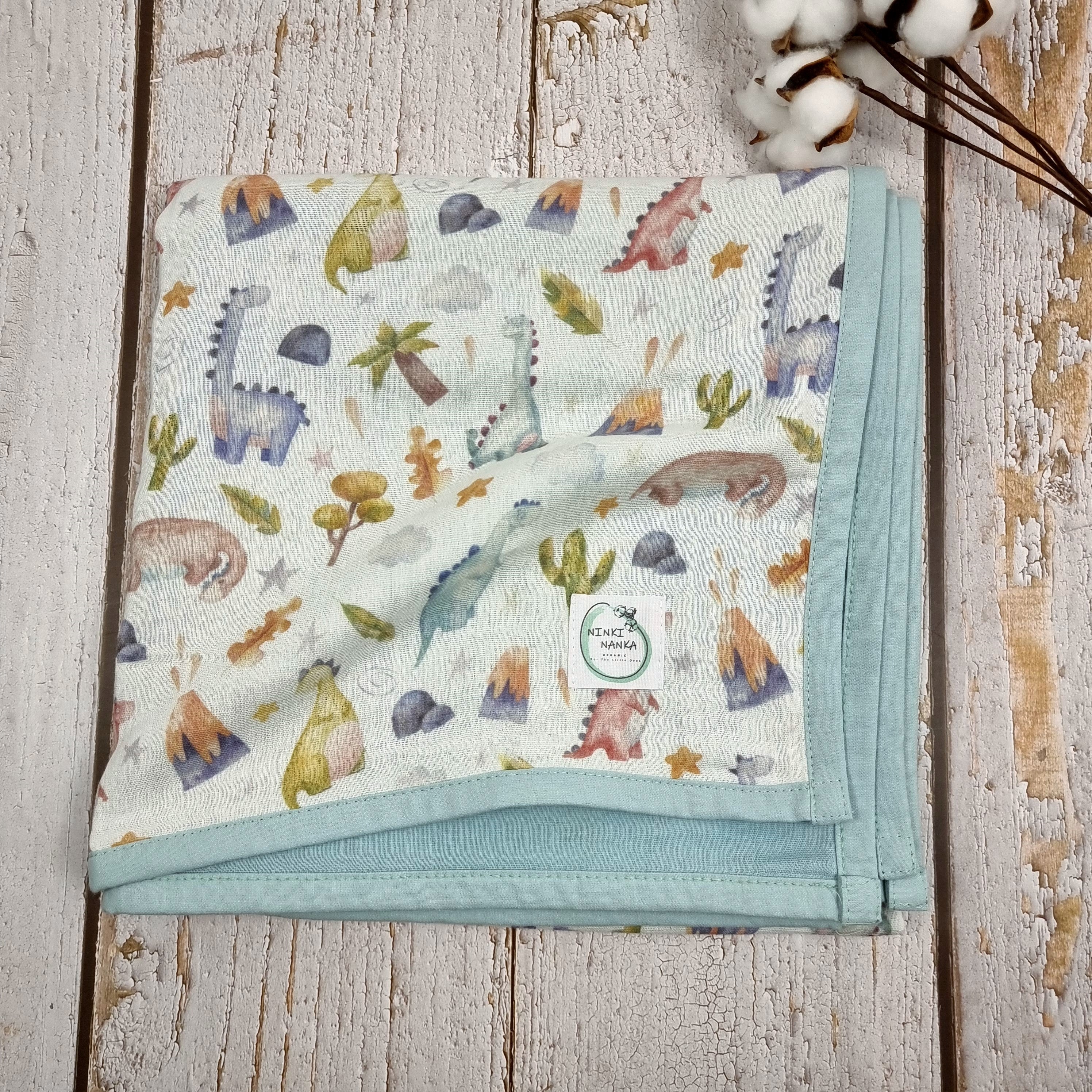 Dinosaur printed double sided organic muslin blanket for babies and toddlers. Light blue & White