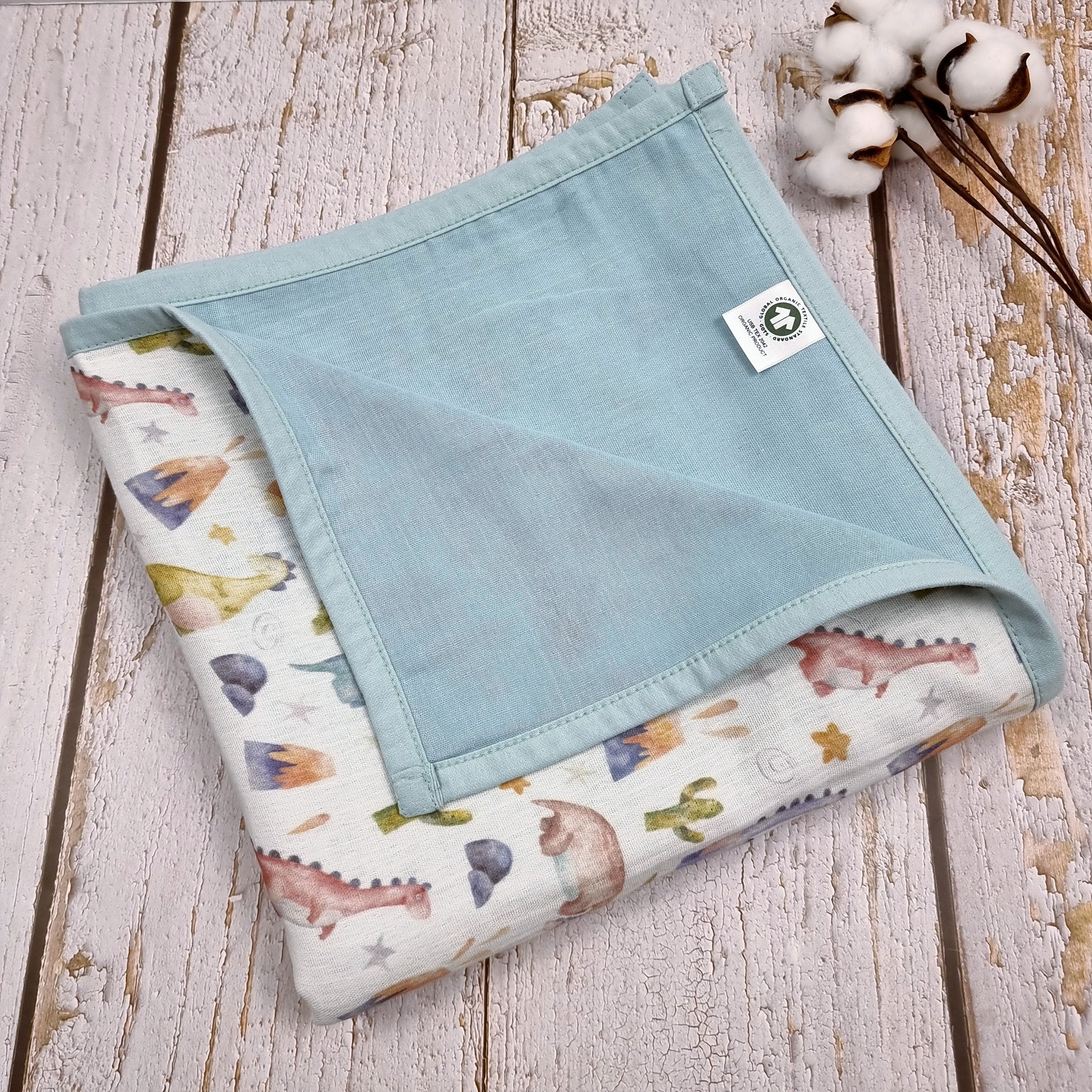 Dinosaur printed double sided organic muslin blanket for babies and toddlers. Light blue & White