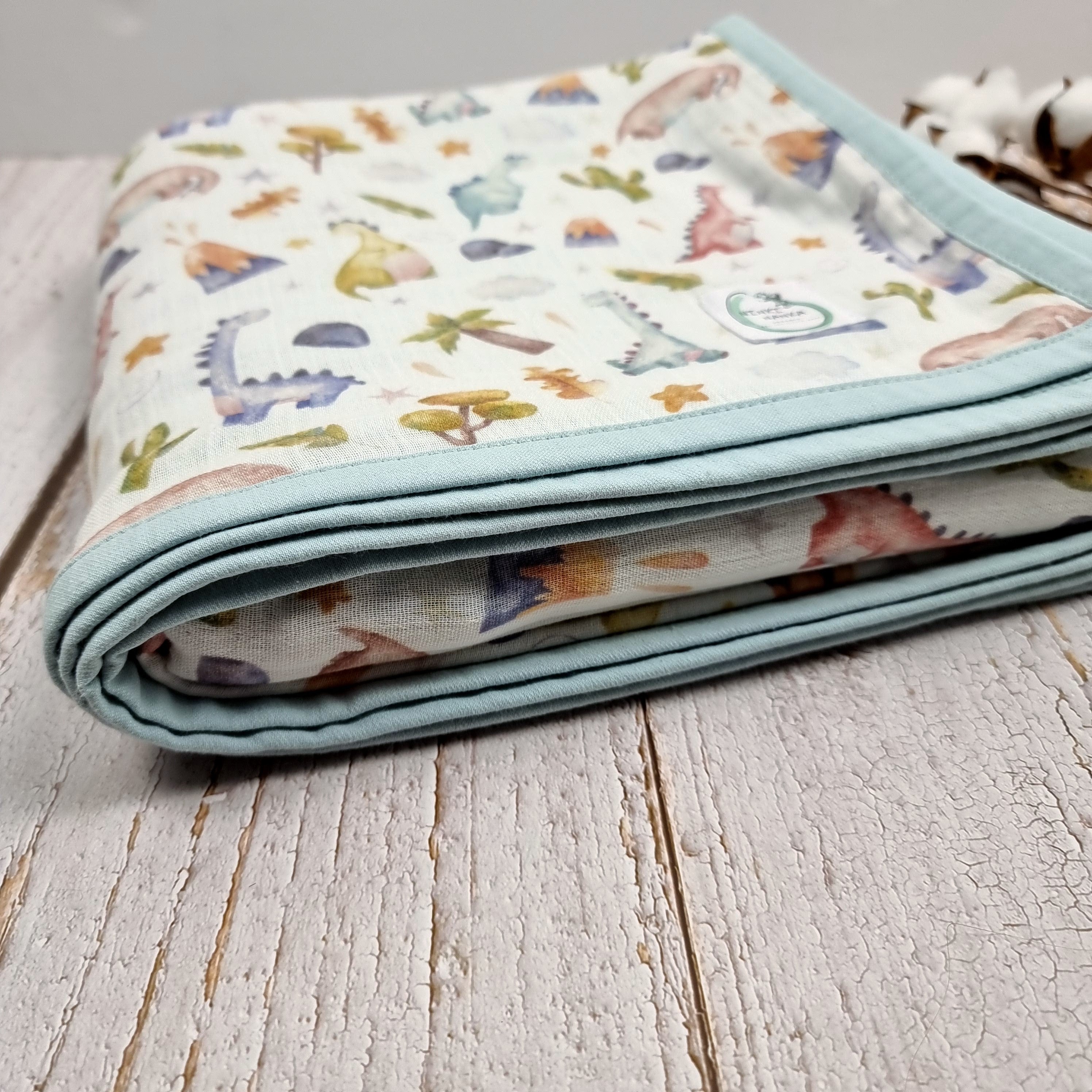 Dinosaur printed double sided organic muslin blanket for babies and toddlers. Light blue & White