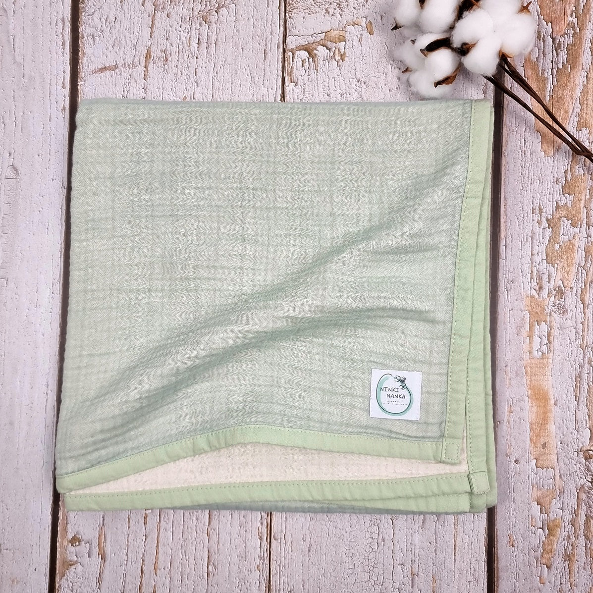 Mint green double sided organic muslin blanket for babies and toddlers. Mint green & ivory