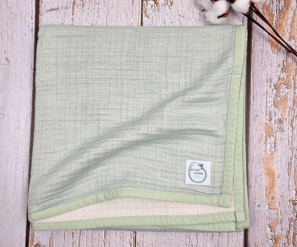 Mint green double sided organic muslin blanket for babies and toddlers. Mint green & ivory