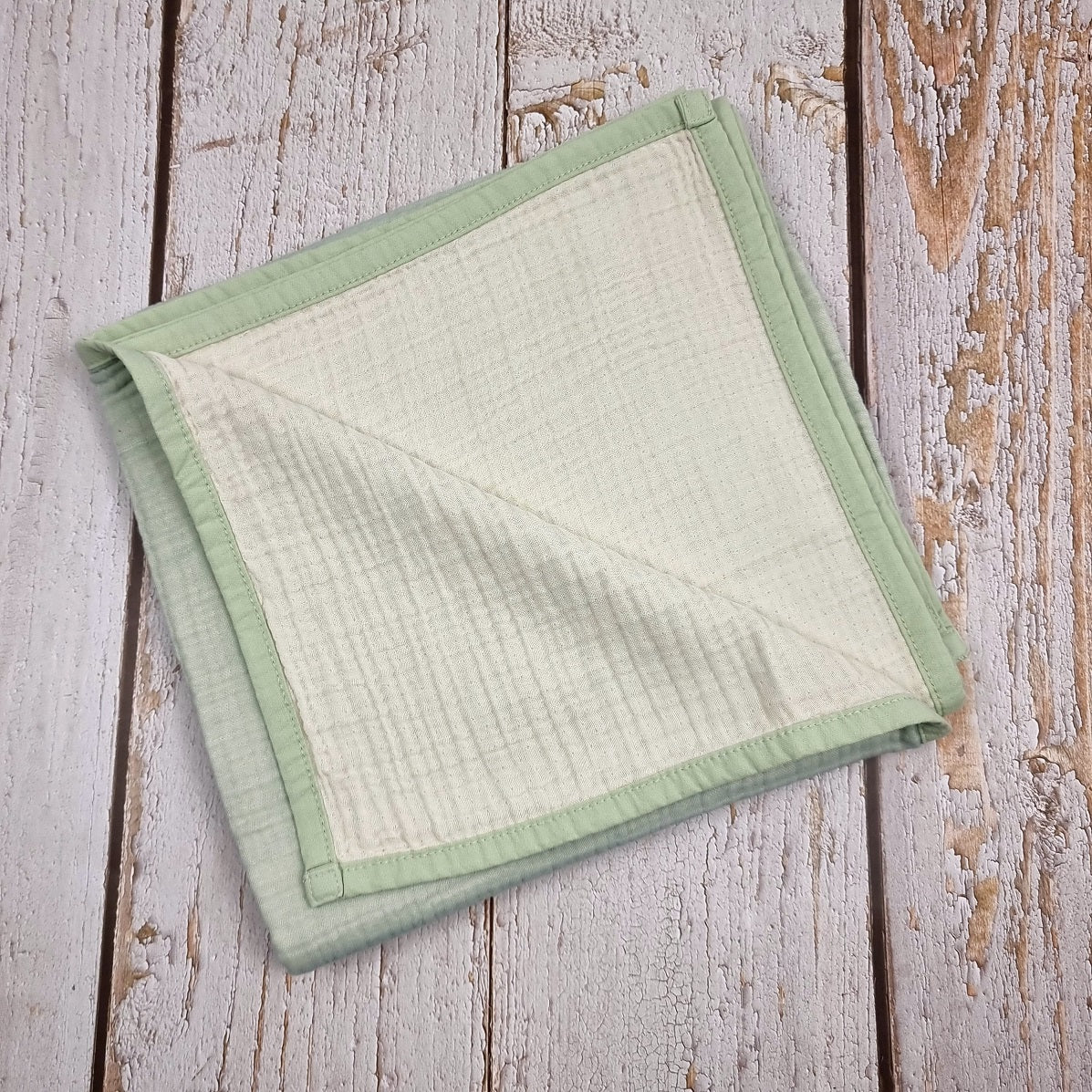 Mint green double sided organic muslin blanket for babies and toddlers. Mint green & ivory