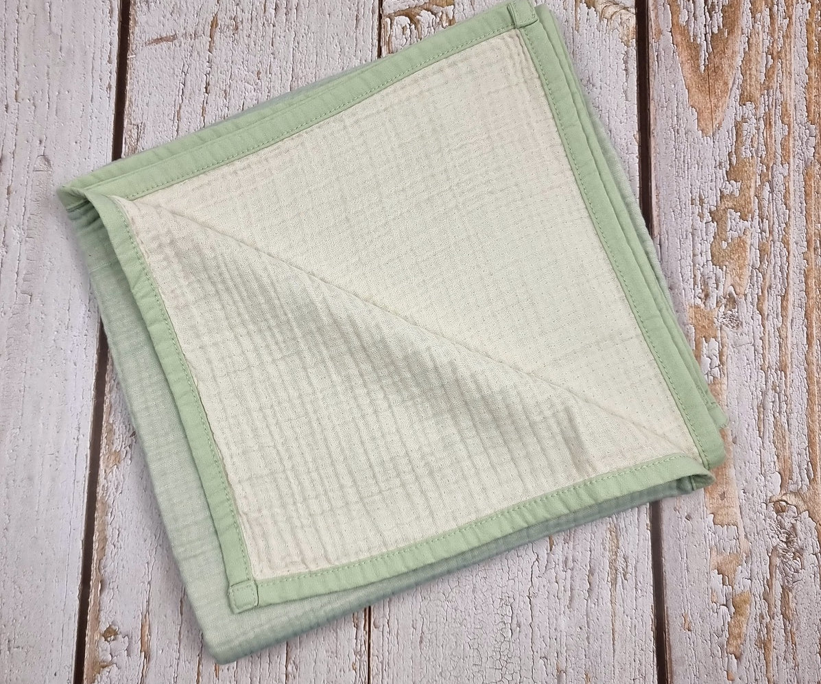 Mint green double sided organic muslin blanket for babies and toddlers. Mint green & ivory