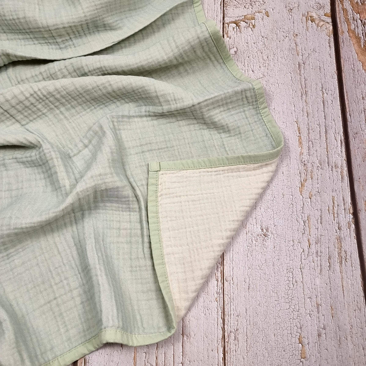 Mint green double sided organic muslin blanket for babies and toddlers. Mint green & ivory