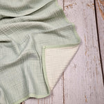 Mint green double sided organic muslin blanket for babies and toddlers. Mint green & ivory