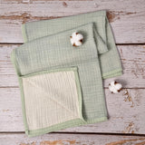 Mint green double sided organic muslin blanket for babies and toddlers. Mint green & ivory